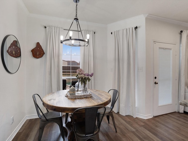 dining room with ornamental molding, an inviting chandelier, dark wood finished floors, and baseboards