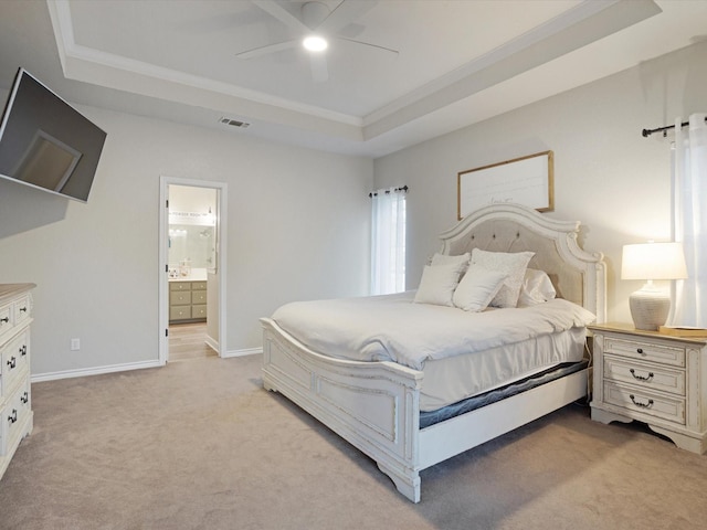 bedroom with light carpet, visible vents, a raised ceiling, and crown molding