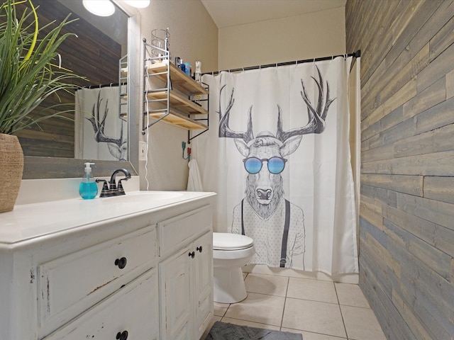 full bathroom featuring tile patterned flooring, toilet, wooden walls, vanity, and a shower with curtain