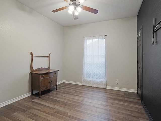 bedroom featuring wood finished floors, a ceiling fan, and baseboards