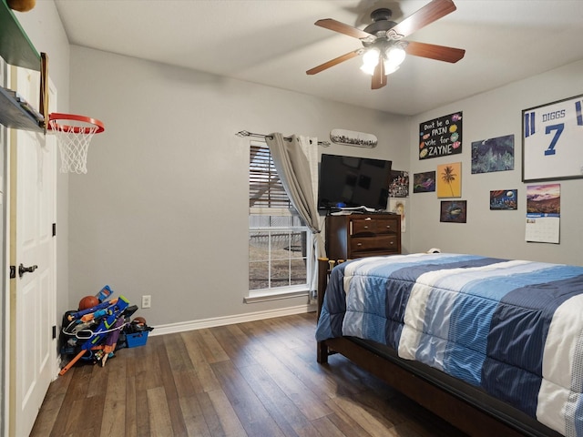 bedroom with a ceiling fan, baseboards, and hardwood / wood-style floors