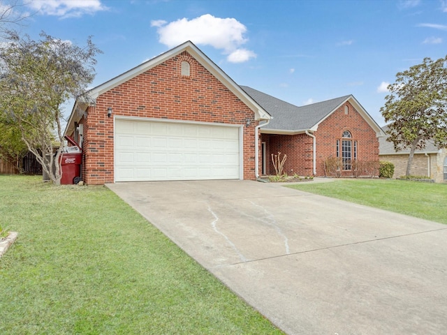 ranch-style home with brick siding, an attached garage, fence, driveway, and a front lawn