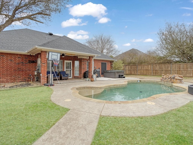 view of swimming pool with a lawn, a patio area, fence, and a hot tub