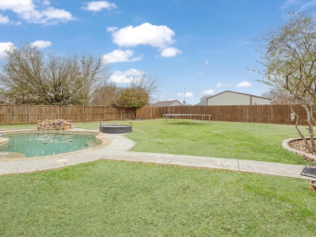 view of yard featuring a fenced backyard, a trampoline, and a fenced in pool