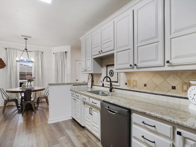 kitchen featuring light wood-style floors, white cabinets, dishwasher, and a sink