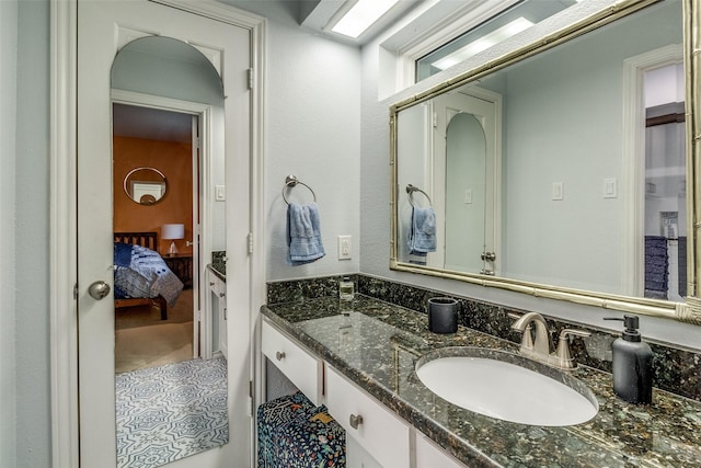 ensuite bathroom featuring connected bathroom and vanity