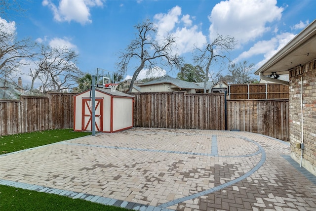 view of patio / terrace with a storage shed, an outdoor structure, and a fenced backyard