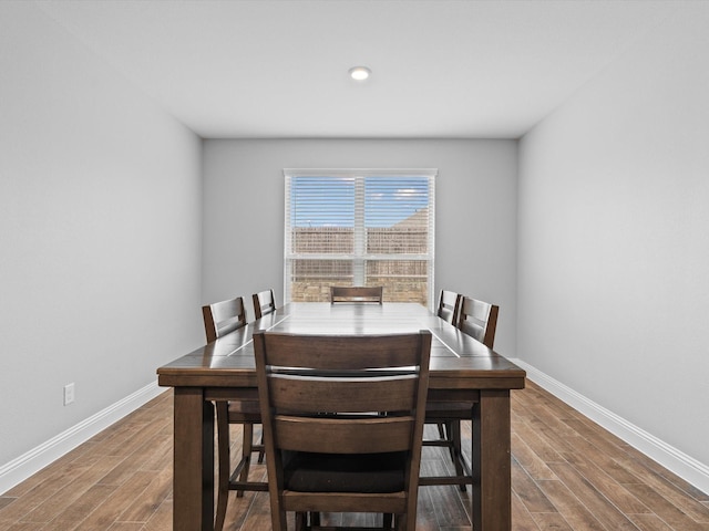 dining area featuring baseboards and wood finished floors