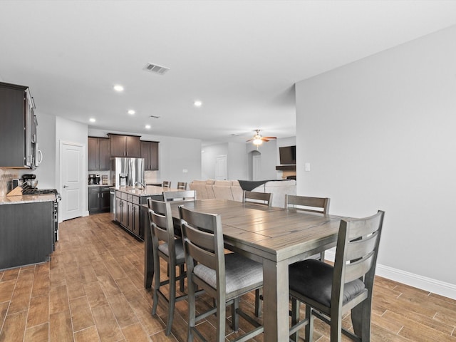 dining room with ceiling fan, recessed lighting, visible vents, baseboards, and light wood-style floors