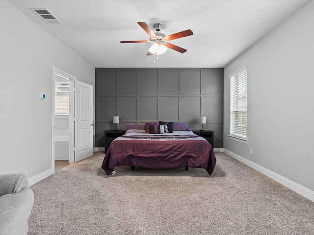 bedroom with visible vents, carpet flooring, and multiple windows