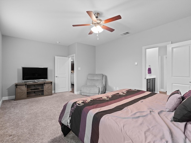 bedroom featuring ensuite bathroom, carpet flooring, visible vents, and baseboards