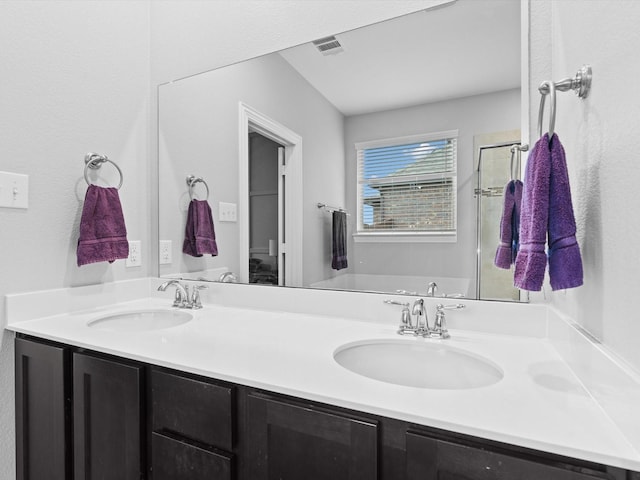 full bath with visible vents, a sink, and double vanity