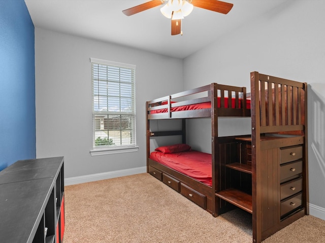 carpeted bedroom featuring ceiling fan and baseboards