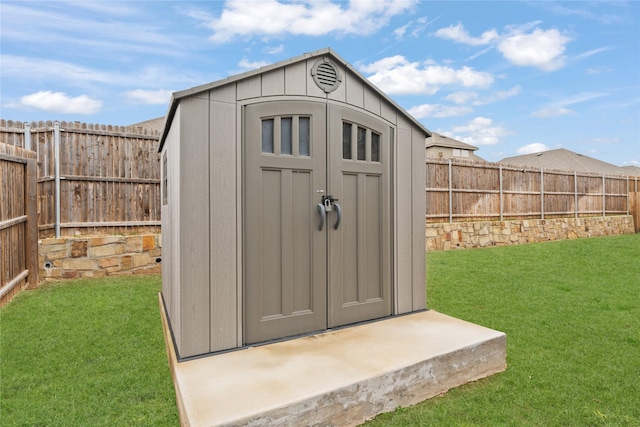 view of shed featuring a fenced backyard