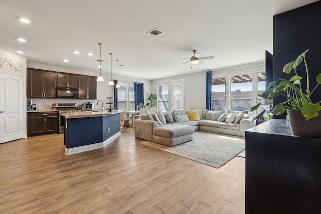 living room with a ceiling fan, recessed lighting, visible vents, and light wood-style floors