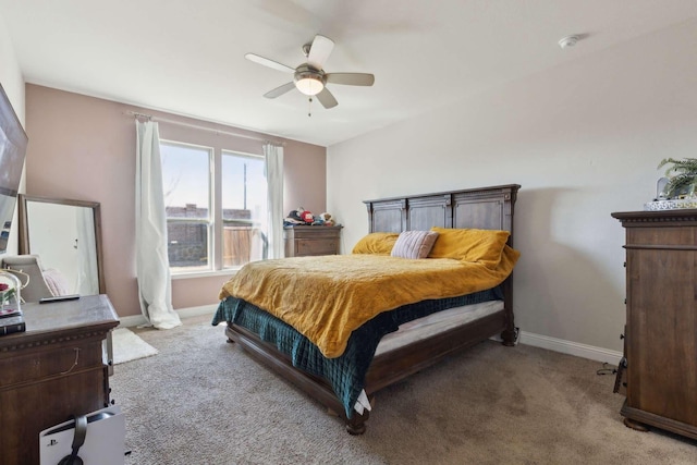 bedroom featuring light carpet, a ceiling fan, and baseboards