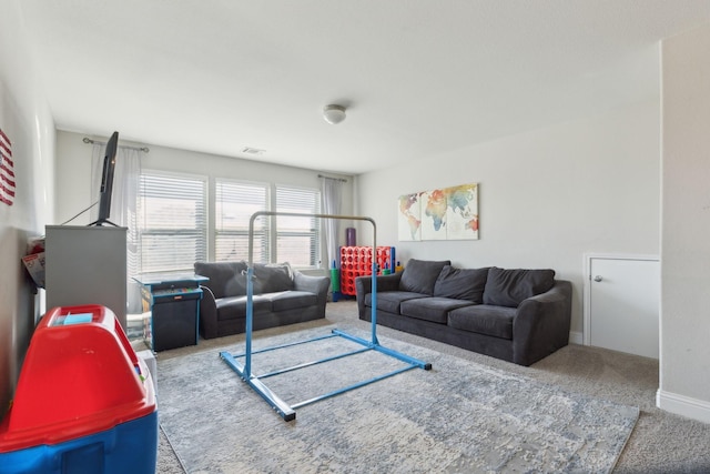 carpeted living room with baseboards and visible vents