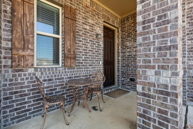 doorway to property featuring brick siding