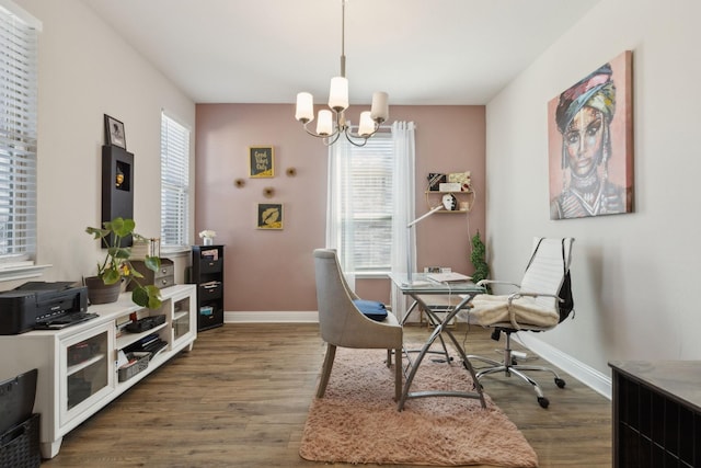 dining area with wood finished floors, a wealth of natural light, and baseboards