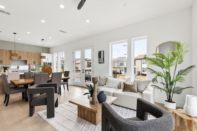 living area with recessed lighting, french doors, and visible vents