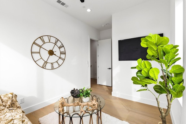 sitting room featuring recessed lighting, wood finished floors, visible vents, and baseboards