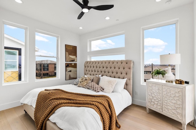 bedroom with a ceiling fan, recessed lighting, baseboards, and wood finished floors