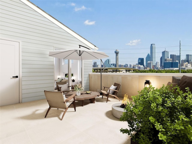 view of patio featuring an outdoor fire pit and a city view