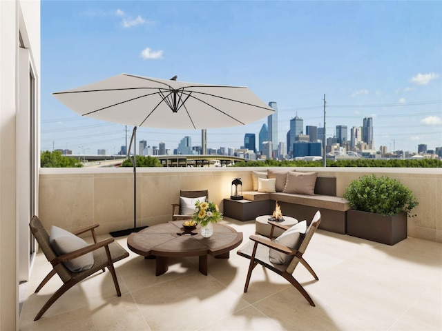 view of patio / terrace with a view of city and an outdoor living space with a fire pit