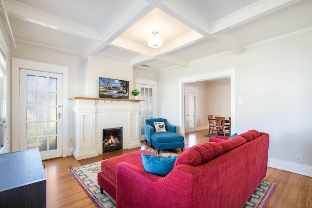 living room with beamed ceiling, wood finished floors, and coffered ceiling