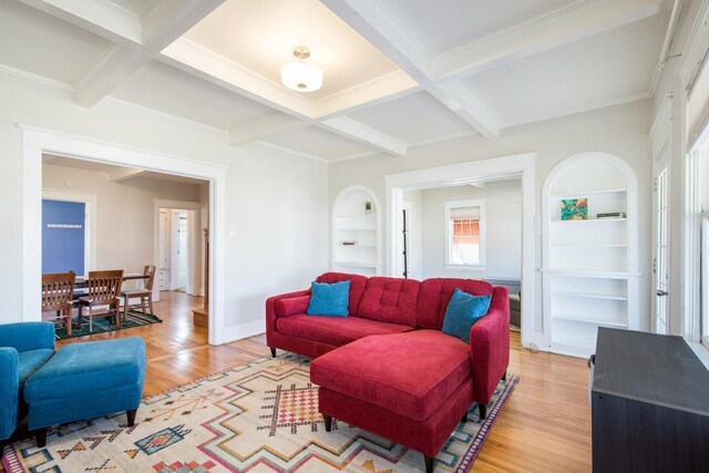 living area with light wood-type flooring, beam ceiling, coffered ceiling, and built in shelves