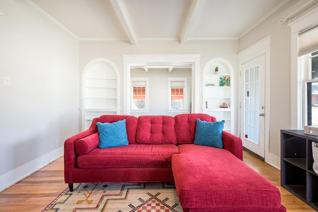 living area featuring beamed ceiling, light wood-type flooring, baseboards, and built in features