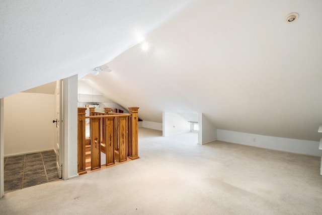 bonus room featuring lofted ceiling and carpet floors