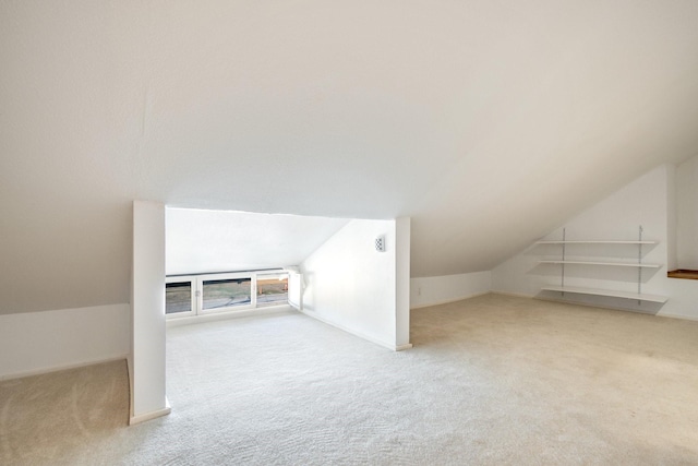 bonus room featuring carpet flooring, baseboards, and lofted ceiling