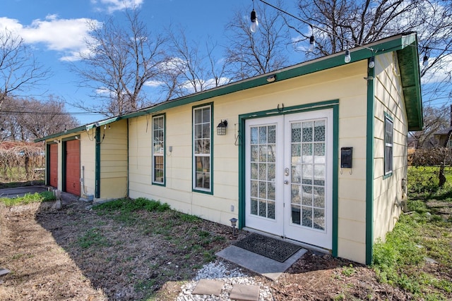 exterior space with french doors and a garage