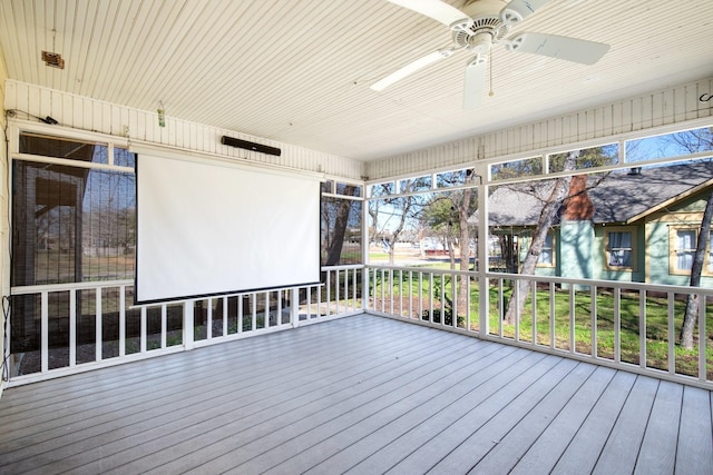 unfurnished sunroom featuring a ceiling fan