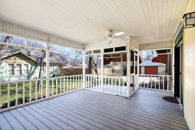 wooden terrace with ceiling fan and fence