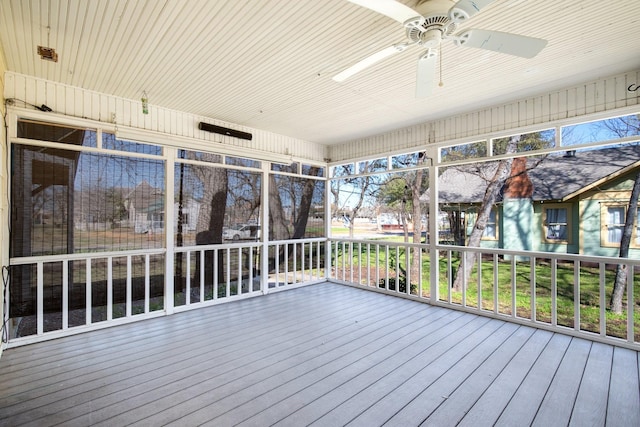 unfurnished sunroom featuring a ceiling fan