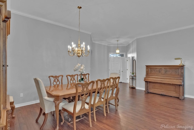 dining area featuring ornamental molding, baseboards, and wood finished floors