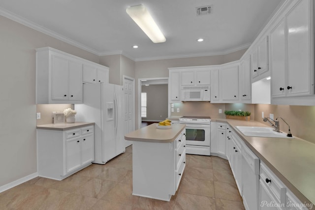 kitchen with visible vents, a kitchen island, light countertops, white appliances, and a sink