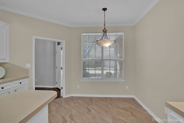 unfurnished dining area featuring baseboards and ornamental molding