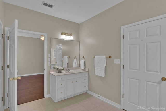 bathroom with visible vents, baseboards, vanity, and tile patterned flooring