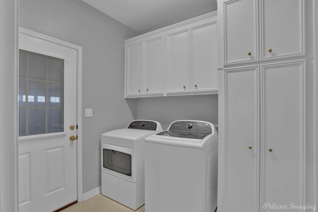 clothes washing area featuring cabinet space, washer and dryer, baseboards, and light tile patterned flooring