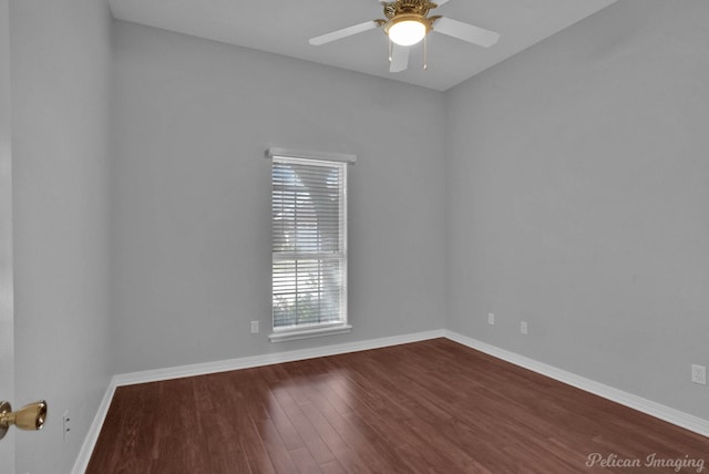 empty room featuring ceiling fan, baseboards, and dark wood-style floors