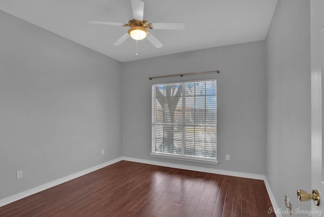 empty room featuring baseboards, wood finished floors, and a ceiling fan