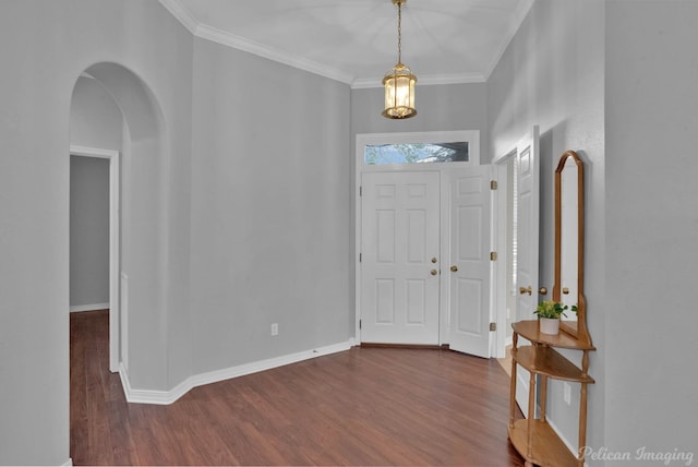 entryway featuring dark wood finished floors, baseboards, arched walkways, and ornamental molding