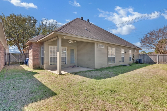 rear view of property with a yard, a patio, a fenced backyard, and a ceiling fan