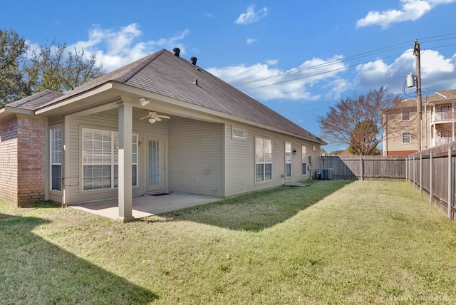 back of house with a yard, a fenced backyard, ceiling fan, a patio area, and brick siding