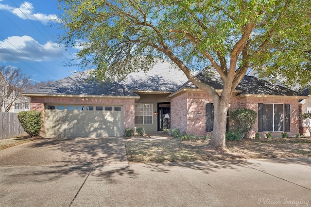 ranch-style house featuring brick siding, an attached garage, driveway, and fence