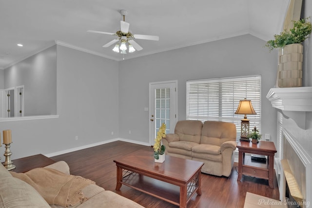 living area with wood finished floors, baseboards, a high end fireplace, ceiling fan, and ornamental molding