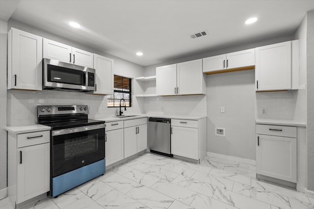 kitchen with marble finish floor, open shelves, stainless steel appliances, light countertops, and a sink